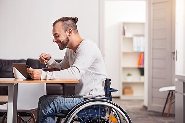 Accessibility - tablet being used by man in wheelchair