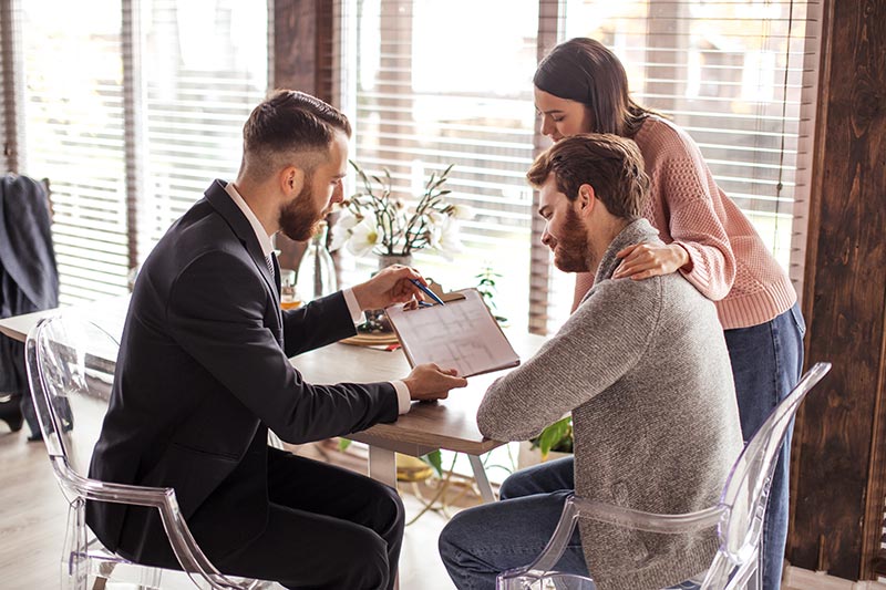 People reviewing a document on a clipboard